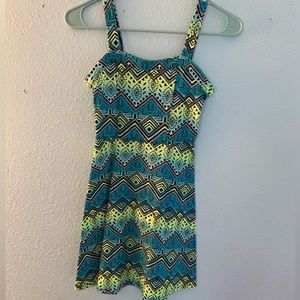 Blue ,green and black zigzag designed shirt with no sleeves.